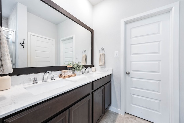 bathroom with vanity and a shower with shower door