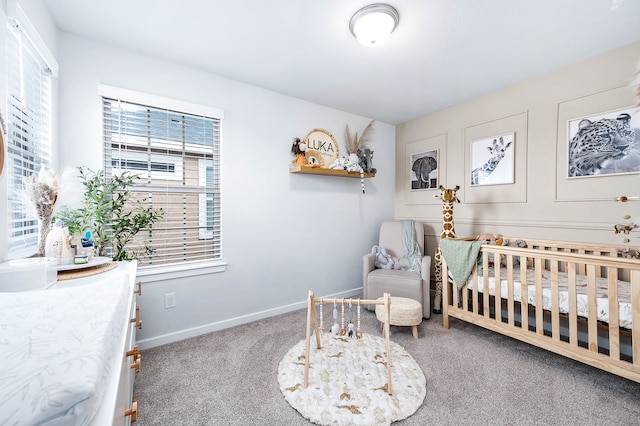 carpeted bedroom featuring a crib