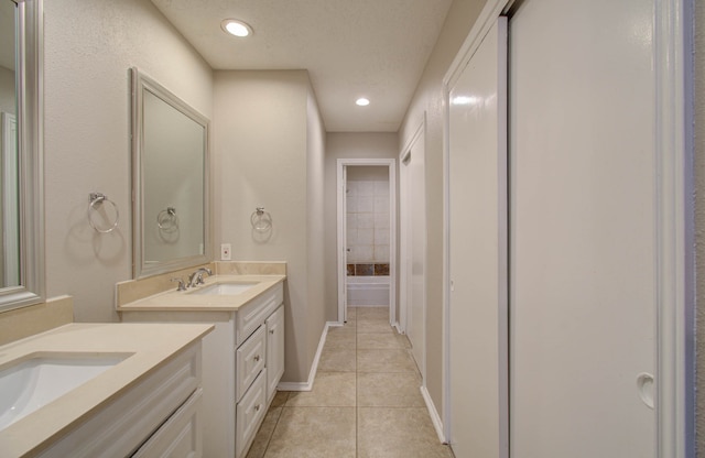 bathroom featuring tile patterned floors, a textured ceiling, and vanity