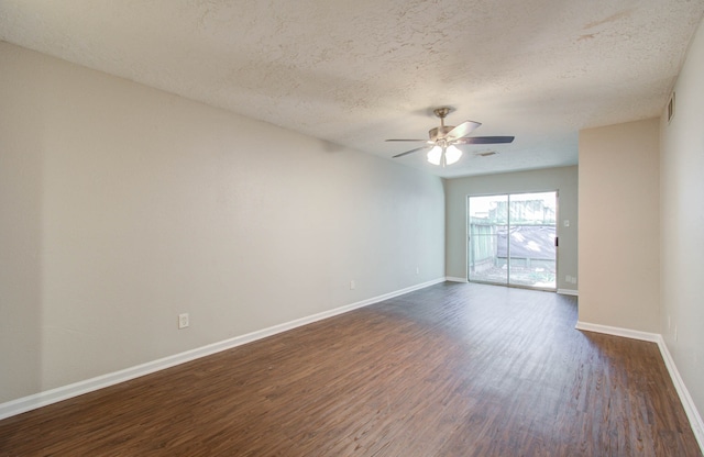 unfurnished room featuring dark wood-type flooring, ceiling fan, and a textured ceiling