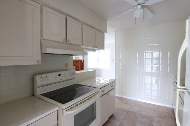 kitchen featuring white cabinetry, tile counters, ceiling fan, and electric stove