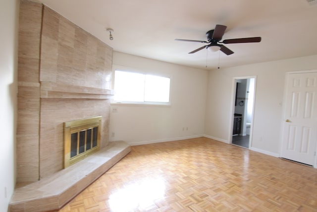 unfurnished living room with light parquet floors, ceiling fan, and a fireplace