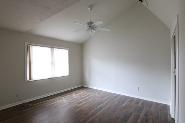 unfurnished room featuring dark wood-type flooring, ceiling fan, and vaulted ceiling