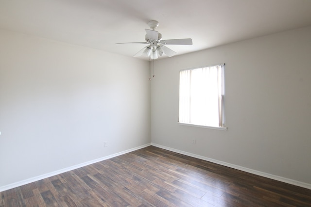 empty room featuring dark wood-type flooring and ceiling fan