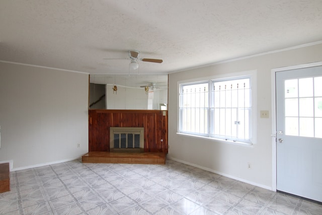 unfurnished living room with ceiling fan, crown molding, and a textured ceiling