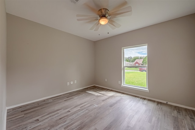 empty room featuring light hardwood / wood-style flooring and ceiling fan