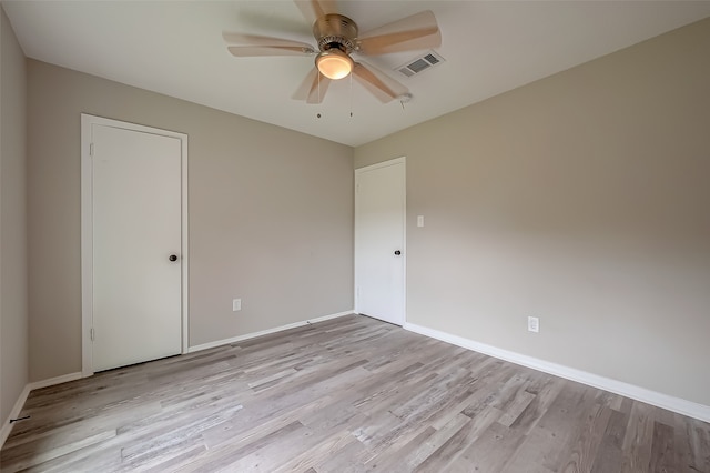 spare room with ceiling fan and light hardwood / wood-style flooring