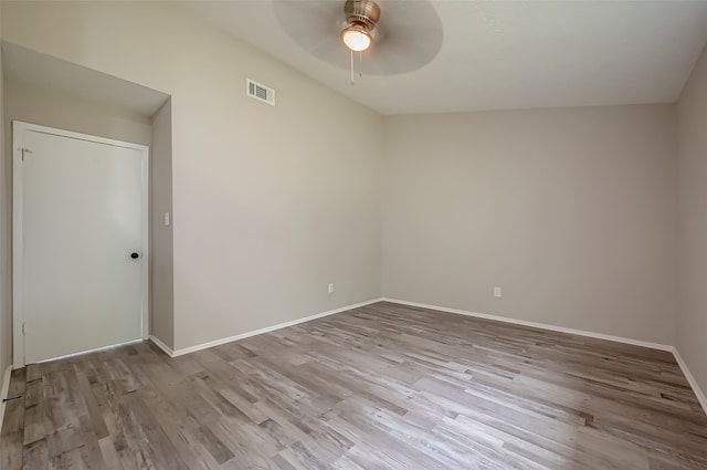 spare room with light wood-type flooring, ceiling fan, and lofted ceiling