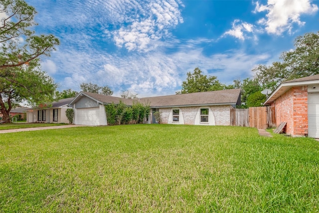 ranch-style house featuring a garage and a front yard