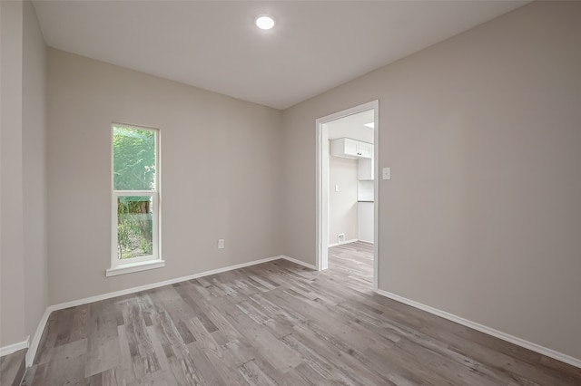 empty room with light hardwood / wood-style flooring