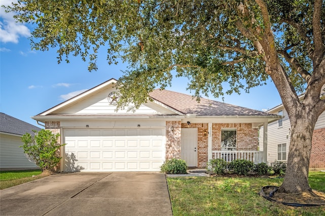 ranch-style home with a garage, a front yard, and a porch