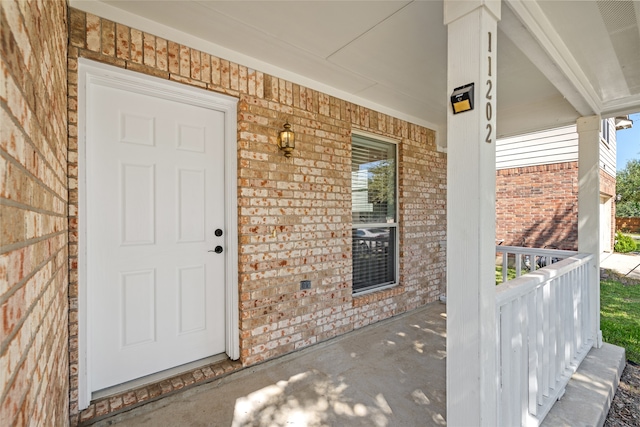 entrance to property featuring covered porch