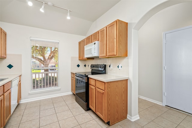 kitchen with lofted ceiling, white appliances, tasteful backsplash, and light tile patterned flooring