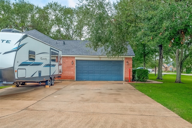 view of front of home with a garage and a front lawn