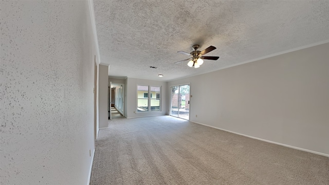 empty room featuring ceiling fan, carpet flooring, and a textured ceiling