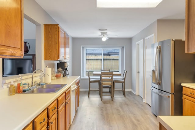 kitchen with ceiling fan, sink, dishwasher, stainless steel refrigerator with ice dispenser, and light hardwood / wood-style floors