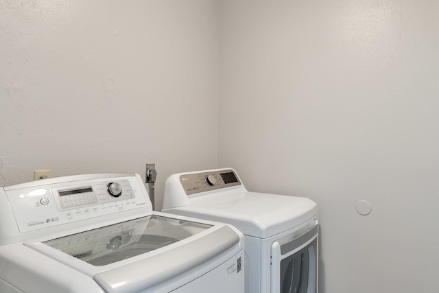 washroom with washing machine and clothes dryer