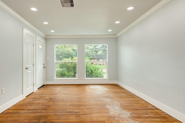 unfurnished room featuring light wood-type flooring and ornamental molding