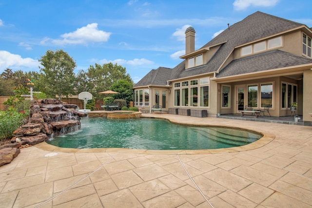 view of swimming pool featuring pool water feature and a patio area