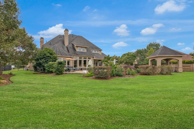 back of house featuring a gazebo, a yard, and a patio