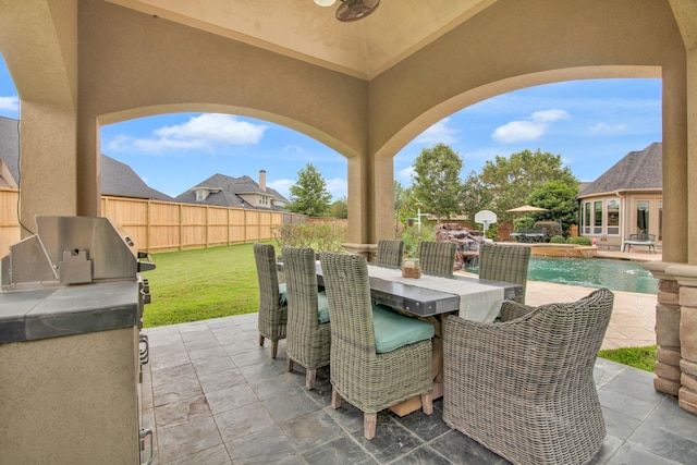 view of patio featuring pool water feature, a fenced in pool, and area for grilling