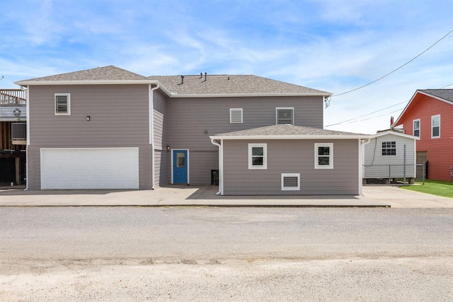 back of property featuring a garage