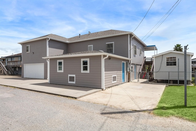 rear view of property featuring a garage