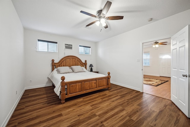 bedroom with dark wood-type flooring, ceiling fan, and multiple windows