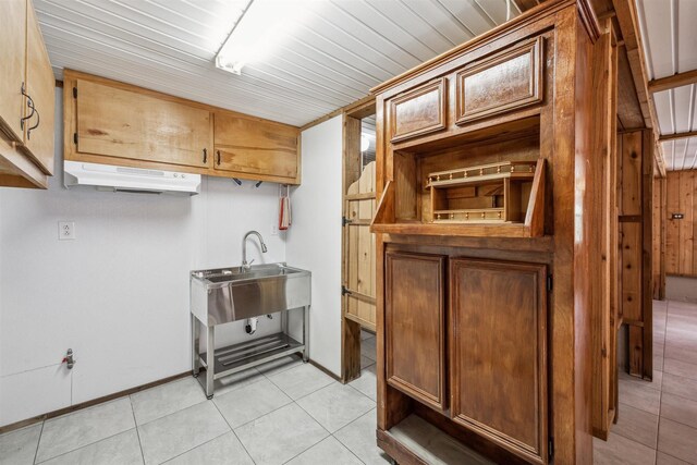 kitchen featuring light tile patterned floors and sink