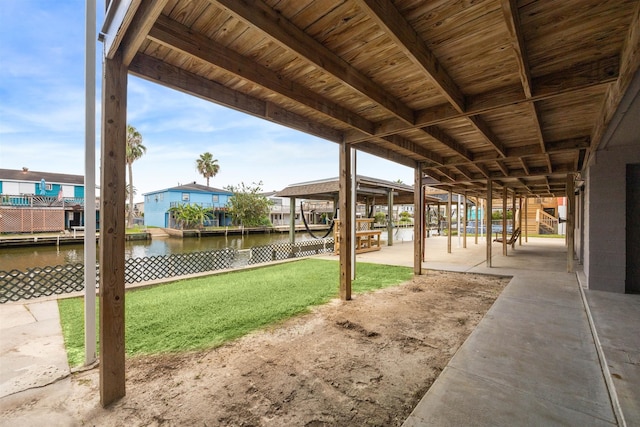 exterior space with a water view and a patio