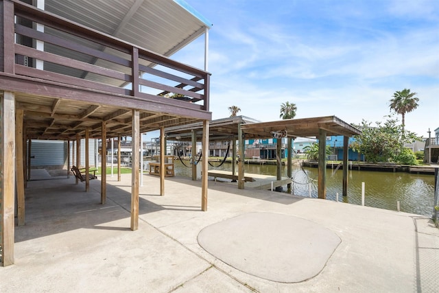 view of patio / terrace featuring a water view and a boat dock