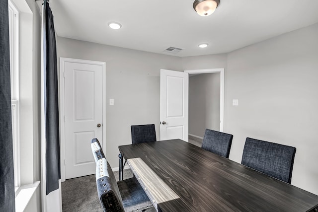 dining area with dark colored carpet