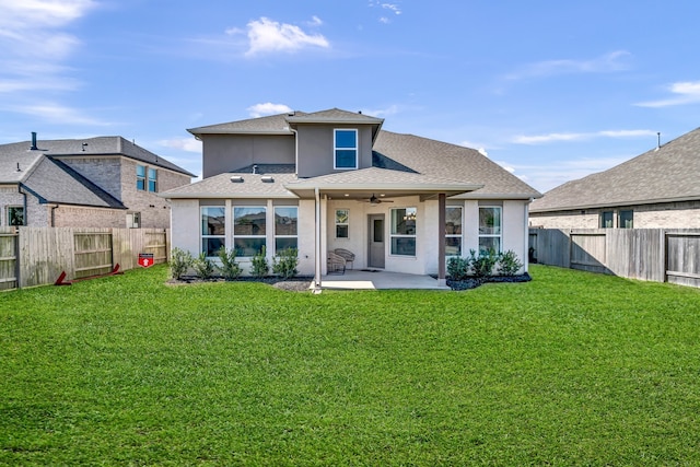 rear view of house featuring a patio area, a yard, and ceiling fan