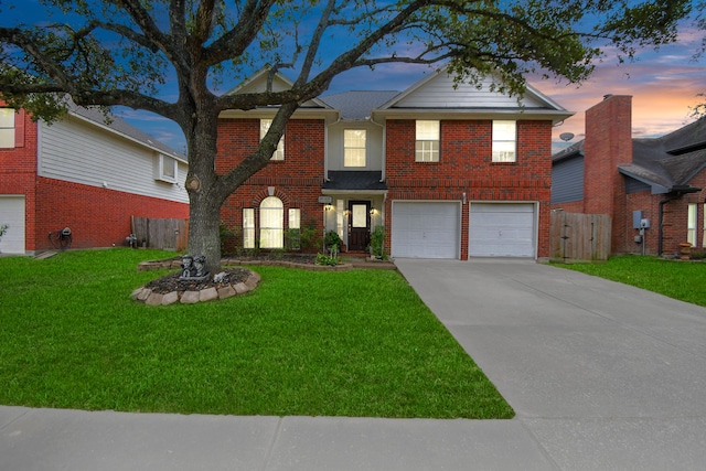 front facade with a yard and a garage