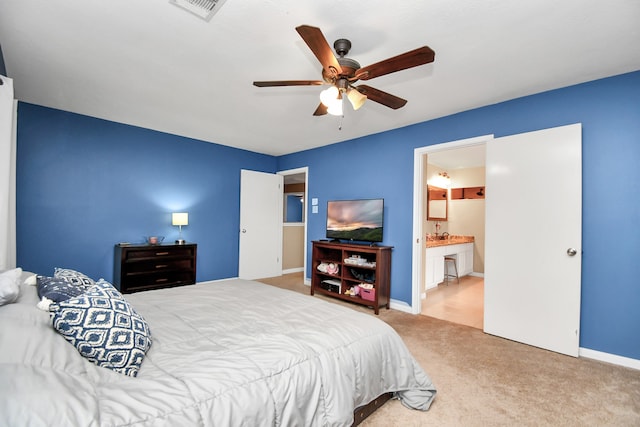 bedroom with ensuite bath, ceiling fan, and light colored carpet