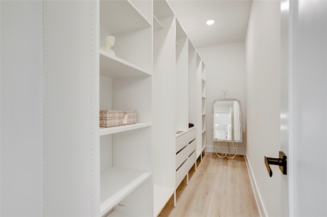 spacious closet featuring light hardwood / wood-style floors