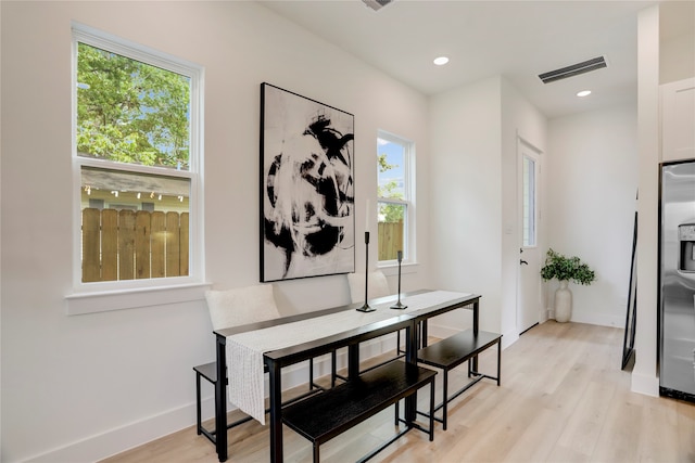 dining room featuring light hardwood / wood-style flooring and a wealth of natural light