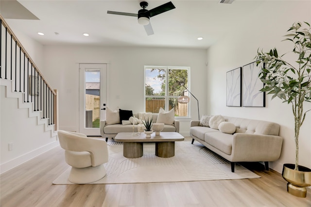 living room featuring ceiling fan and light wood-type flooring