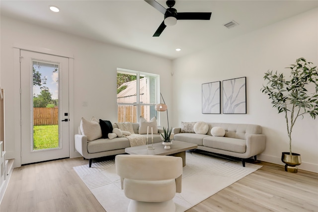 living room featuring light wood-type flooring and ceiling fan