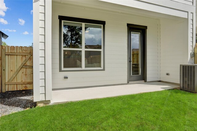 exterior space featuring central air condition unit, a patio, and a lawn