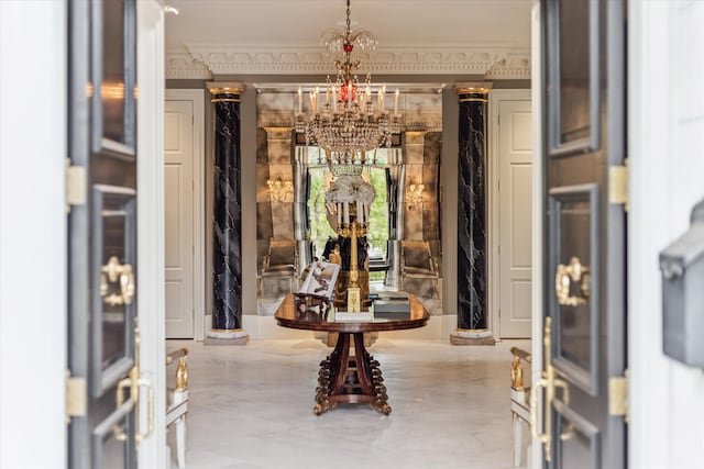 interior space with ornamental molding and an inviting chandelier