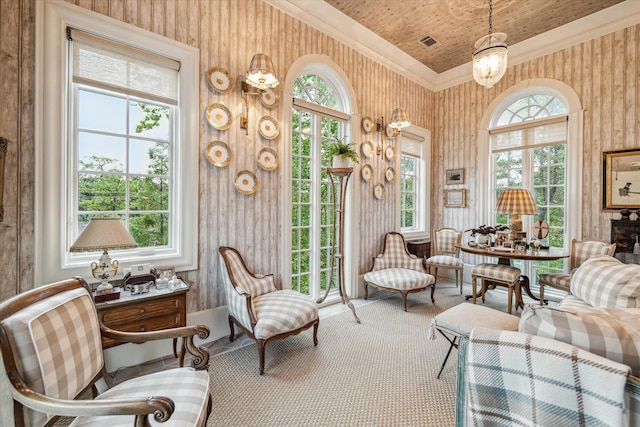 sitting room featuring crown molding, plenty of natural light, and carpet floors