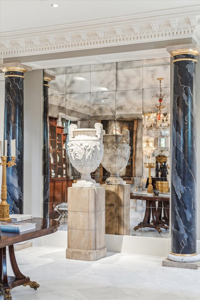 wine cellar with crown molding and ornate columns