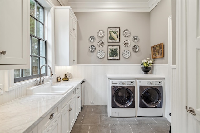 laundry room with a wealth of natural light, crown molding, washer and clothes dryer, and sink