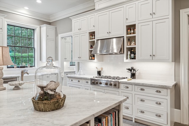 kitchen with ornamental molding, ventilation hood, and light stone countertops