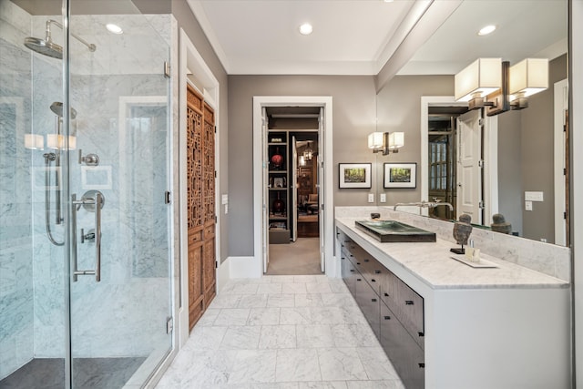 bathroom featuring an enclosed shower and vanity