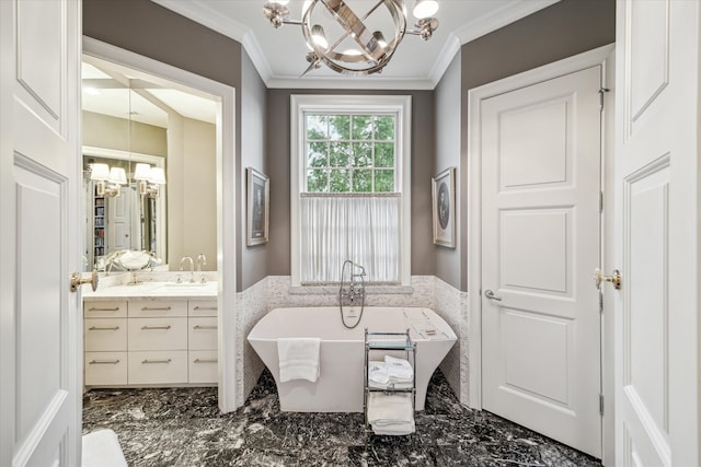 bathroom featuring crown molding, vanity, an inviting chandelier, and a bathtub