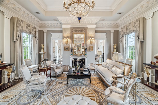 living room featuring a healthy amount of sunlight, ornamental molding, and decorative columns