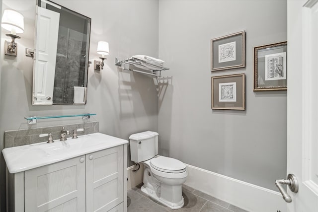 bathroom featuring tile patterned flooring, toilet, and vanity