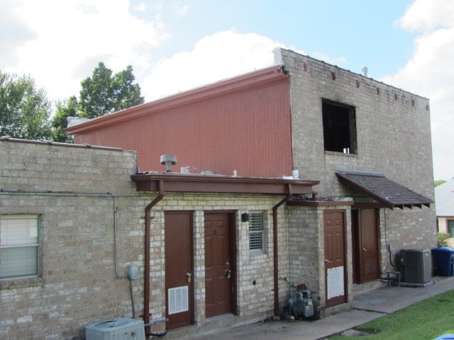 back of house featuring central air condition unit